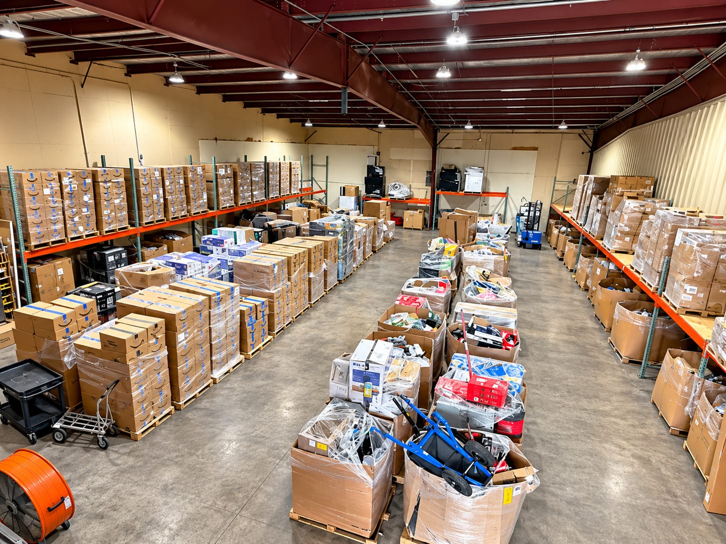 Racked and floor-stacked pallets down the main aisle of the warehouse